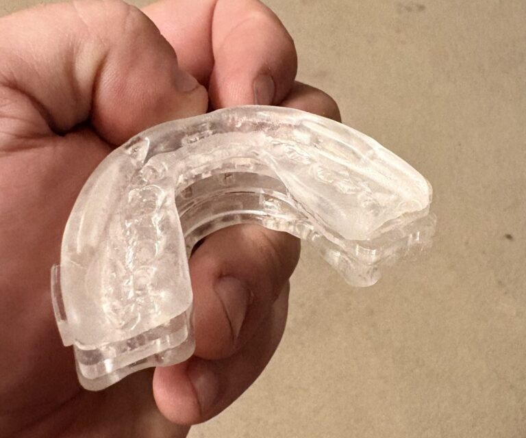 Difiney anti-snoring mouthpiece top view showing molded teeth impressions